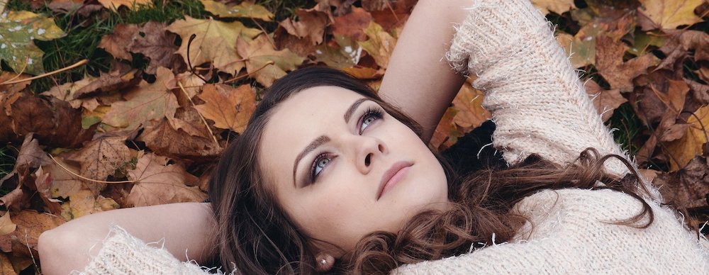 Girl in autumn with changing leaves