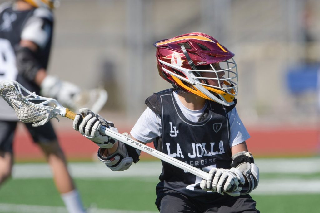 A San Diego youth lacrosse player stands poised and ready